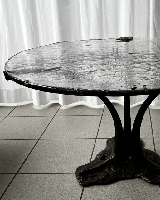 A sculptural metal base and textured glass.